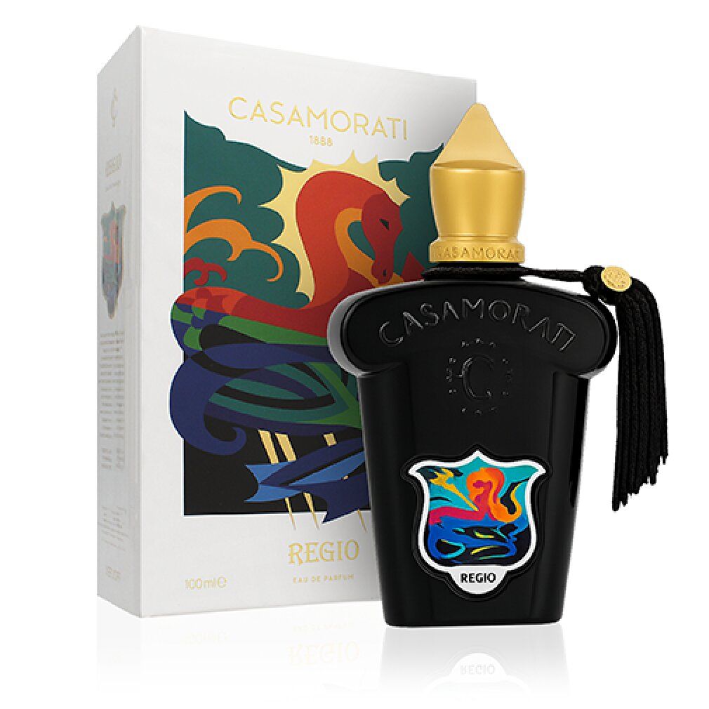Schwarzer Flakon mit goldener Kappe und Quaste. Weiße Verpackung mit farbiger Illustration und Schriftzug REGIO.