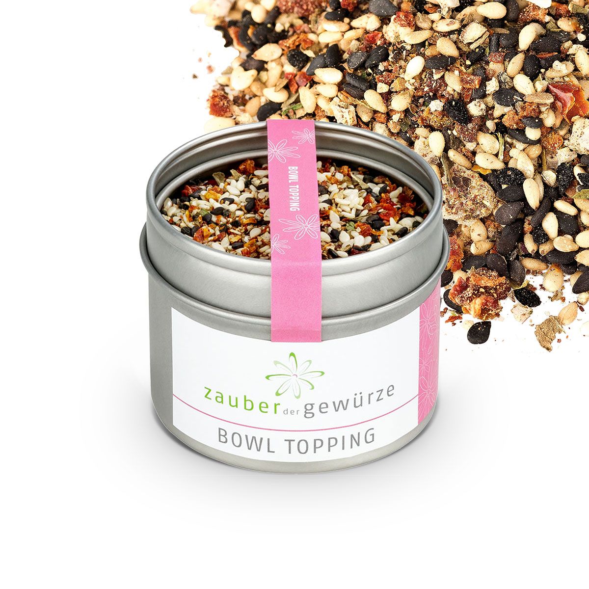 Geöffnete Dose Zauber der Gewürze Bowl Topping. Gewürzmischung daneben. Rosa Band mit Aufschrift.