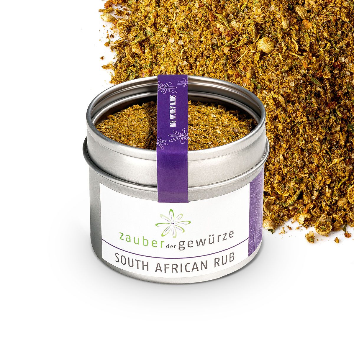 Geöffnete Gewürzdose 'Zauber der Gewürze South African Rub'. Dose, Gewürzmischung, lila Band, Gewürze daneben.