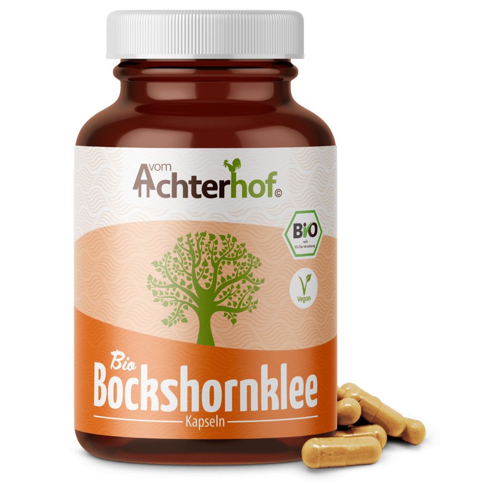Braune Flasche mit weißen Deckel. Aufschrift: Achterhof Bio Bockshornklee Kapseln. Bio-Siegel und veganes Logo. Einige Kapseln liegen daneben.