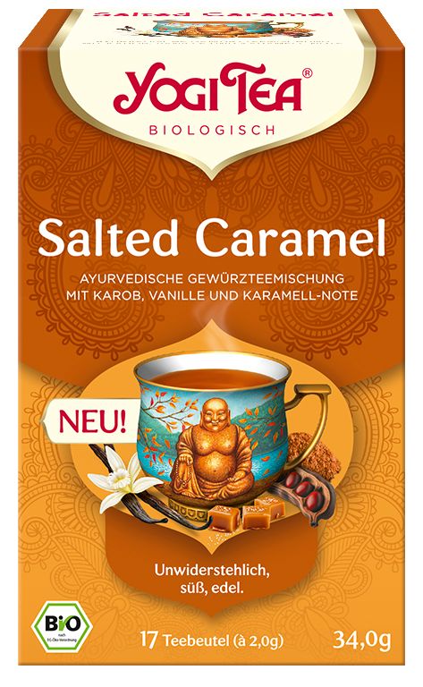 Verpackung mit Yogi Tea Salted Caramel. Aufdruck: ayurvedische Gewürzteemischung, 17 Teebeutel, Bio-Siegel. Abbildung einer Tasse Tee mit Buddha.