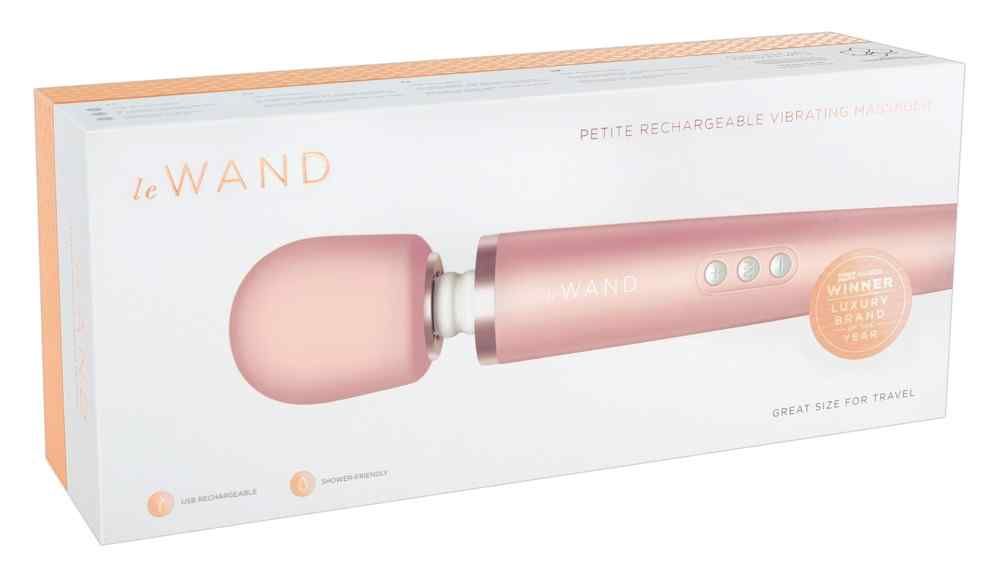 Rosegoldfarbenes Wellness-Produkt in Verpackung. Aufschrift "le Wand". Mit drei Knöpfen und Zertifizierung.
