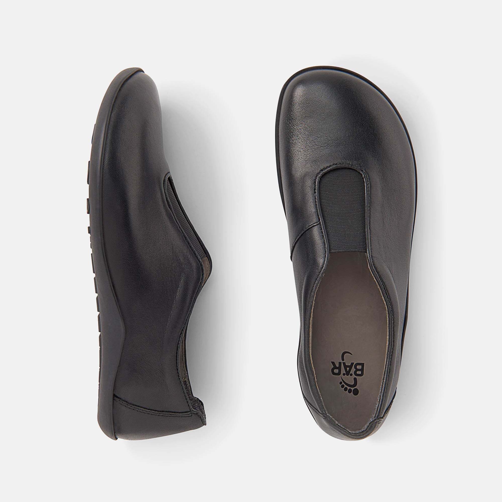 Schwarze Damen-Slipper aus Leder, Draufsicht, mit elastischem Einsatz und flacher Sohle.