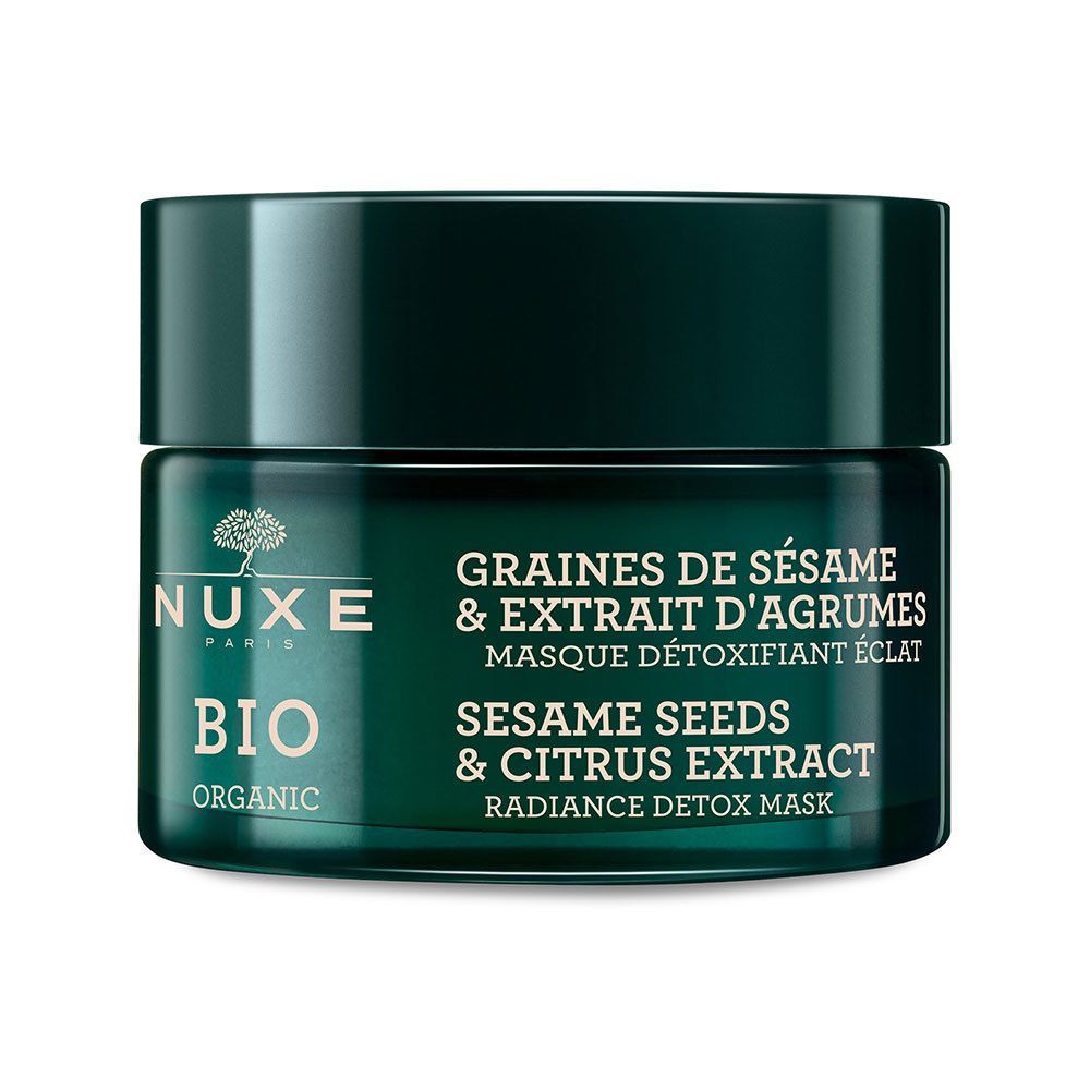Grüne Tiegel mit NUXE BIO-Gesichtsmaske. Text: GRAINES DE SÉSAME & EXTRAIT D'AGRUMES, MASQUE DÉTOXIFIANT ÉCLAT, SESAME SEEDS & CITRUS EXTRACT, RADIANCE DETOX MASK.