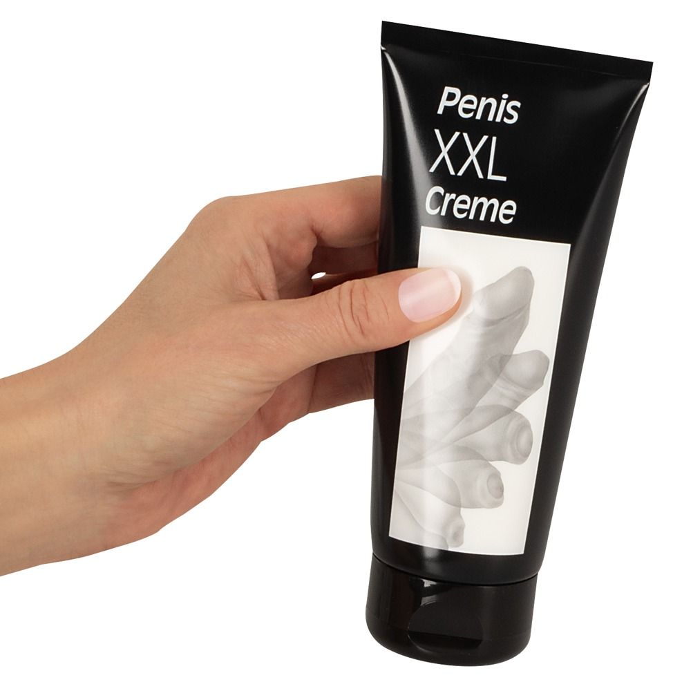 Hand hält schwarze Tube. Aufschrift: Penis XXL Creme. Weißes Etikett mit Penis-Abbildung.