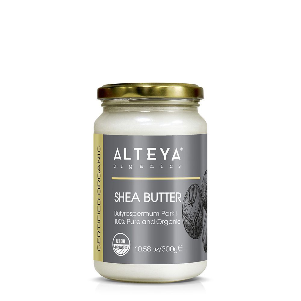 Glas Shea Butter Tiegel. Deckel goldfarben. Etikett mit Markenname, Produktname und USDA-Bio-Siegel. 10.58 oz/300g.