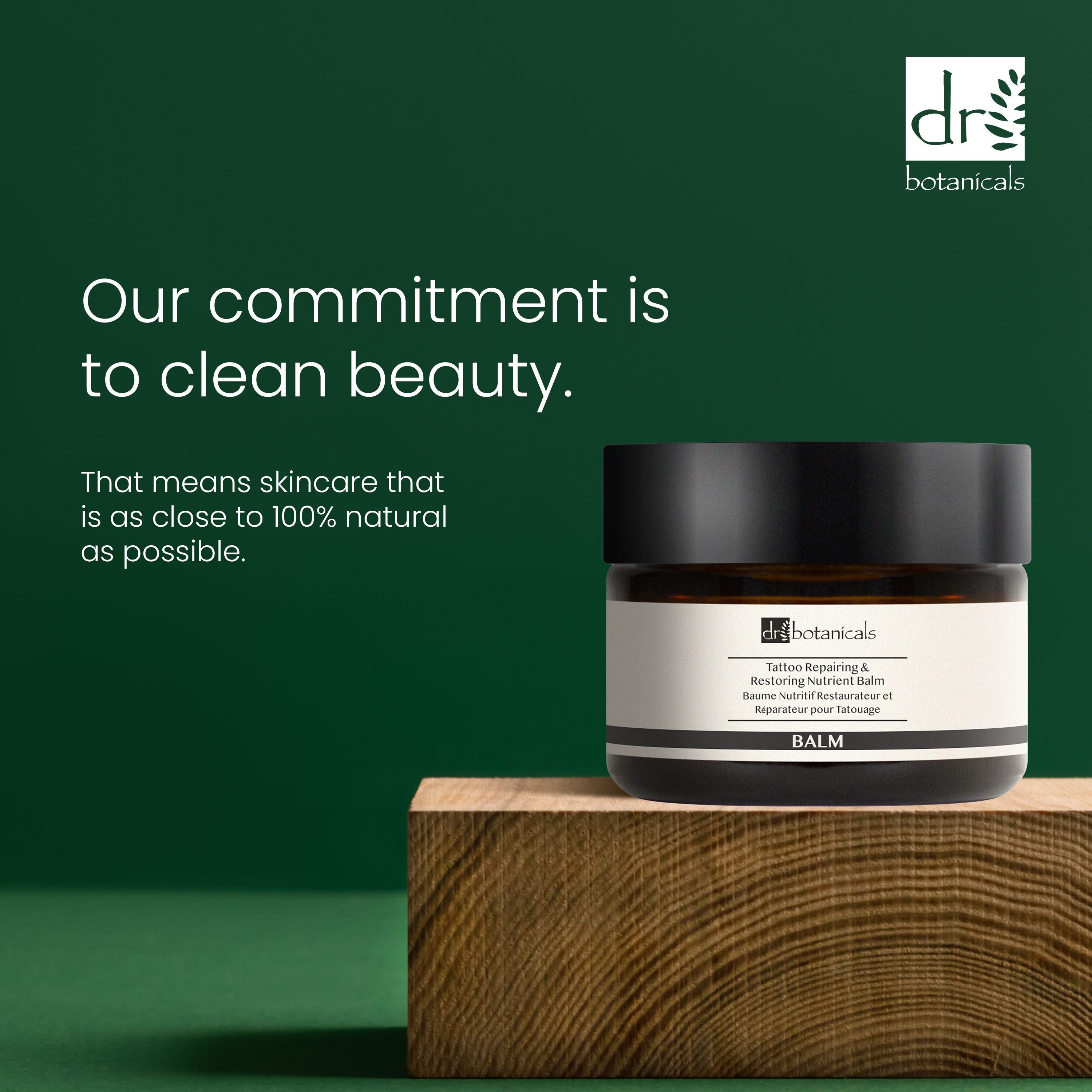 Dose auf Holzblock. Aufschrift: Tattoo Repairing & Restoring Nutrient Balm. Text: Our commitment is to clean beauty.