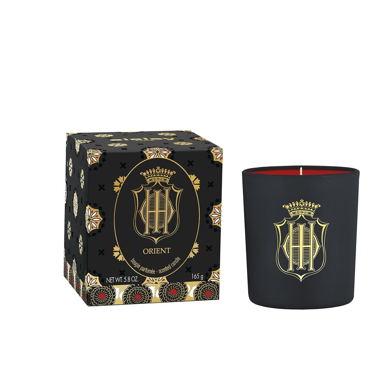 Schwarze Kerze und Schachtel. Goldfarbenes Logo. Aufschrift: Orient, Bougie parfumée.