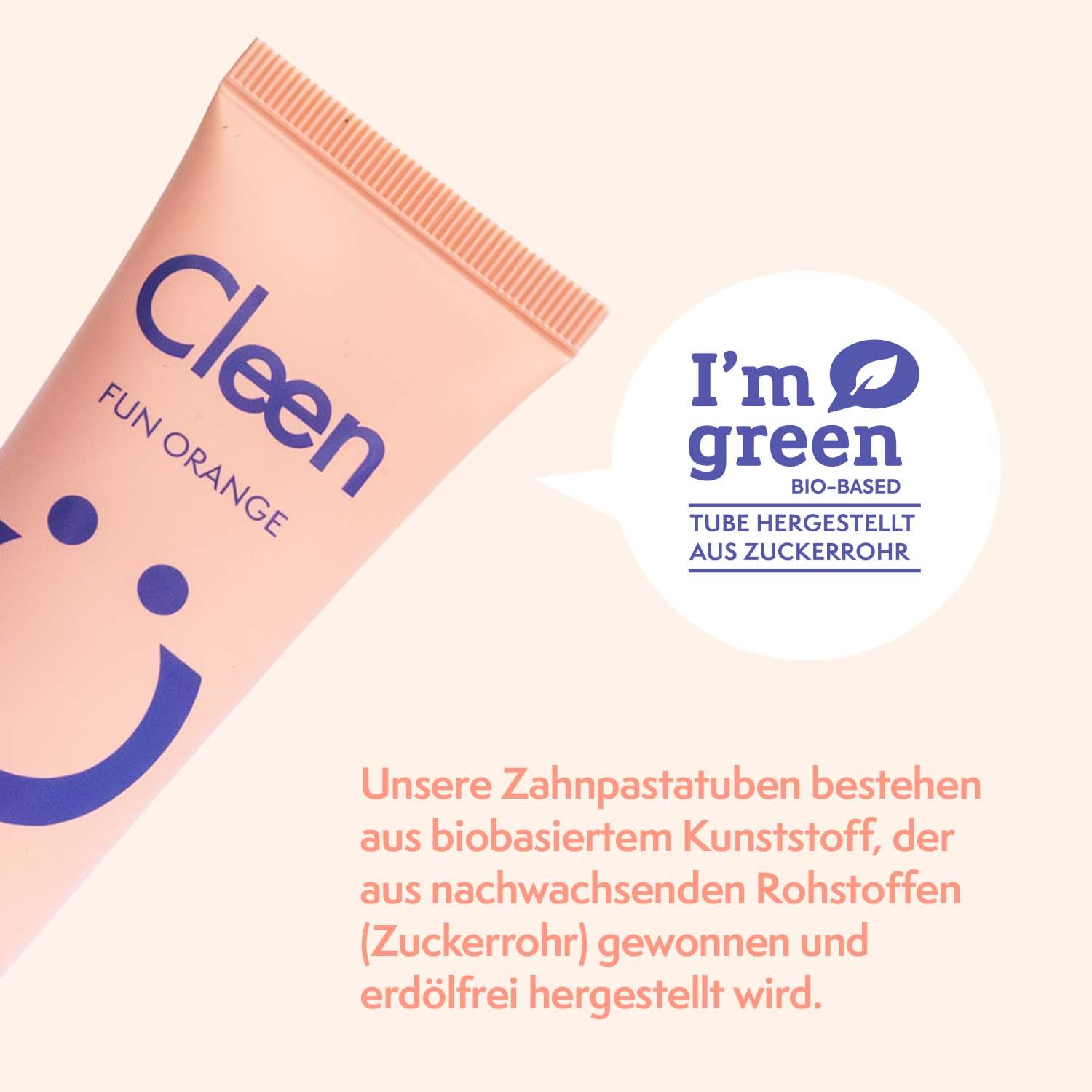 Zahngel-Tube, orangefarben, mit blauem Smiley-Gesicht. Text: Cleen, Fun Orange. I'm green. Tube hergestellt aus Zuckerrohr.