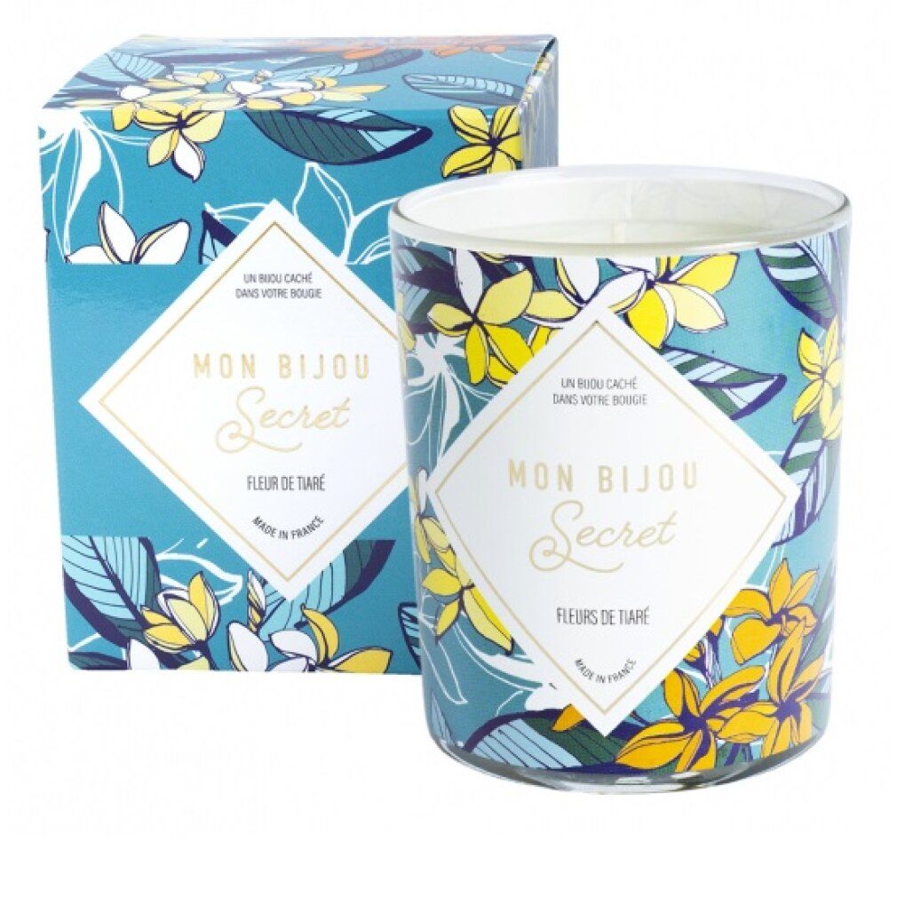 Zylinderförmige Kerze mit floralem Muster und Verpackung. Aufschrift "Mon Bijou Secret, Fleurs de Tiaré".