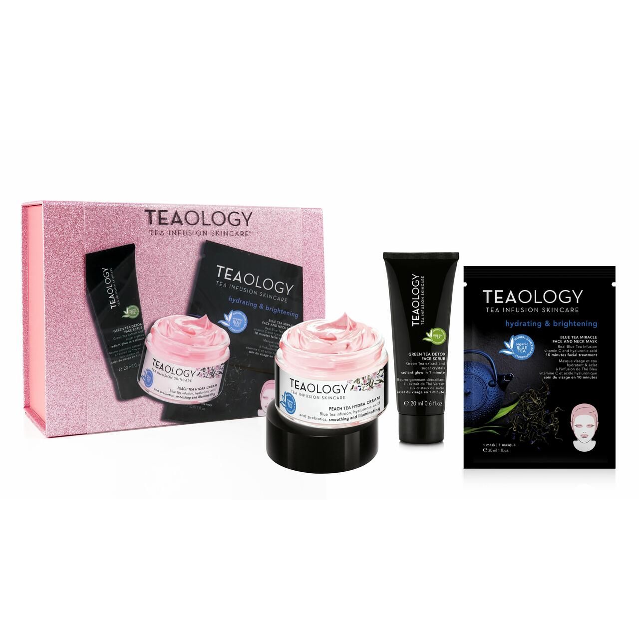 Geschenkset mit rosa Creme, schwarzer Tube, Tuchmaske und rosa Box mit Logo. Aufschrift: Teaology.