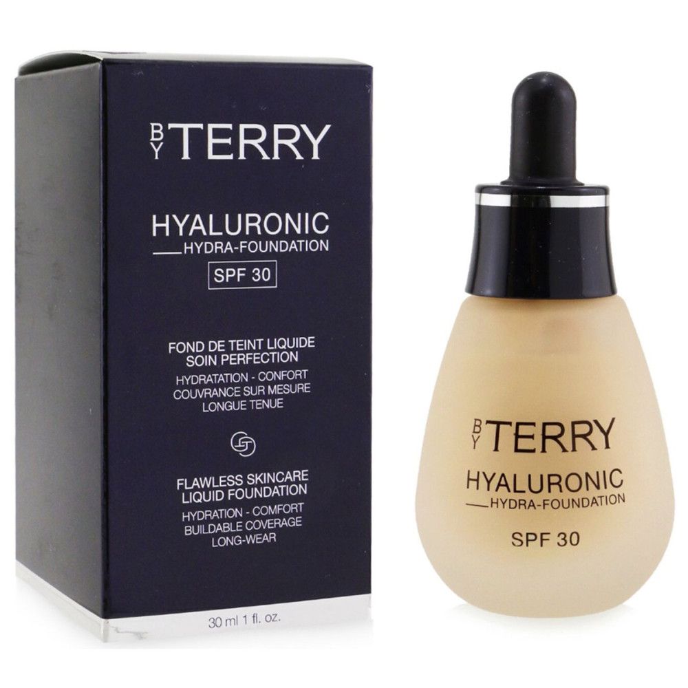 Foundation-Flasche und Schachtel. Aufschrift: BY TERRY, Hyaluronic Hydra-Foundation, SPF 30. Text in Französisch und Englisch.
