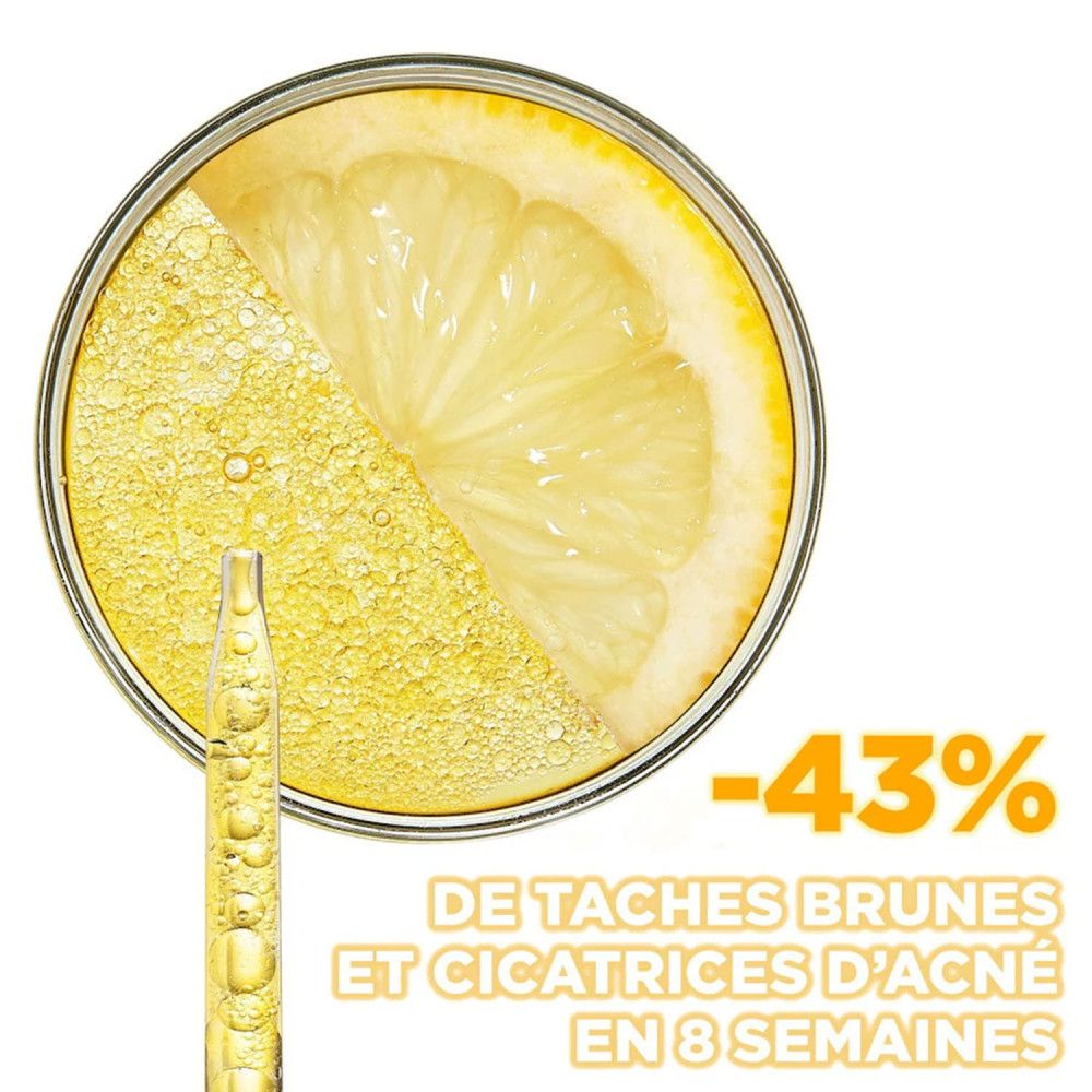 Zitrone in Petrischale mit Serum und Pipette. Text: -43% DE TACHES BRUNES ET CICATRICES D'ACNÉ EN 8 SEMAINES.