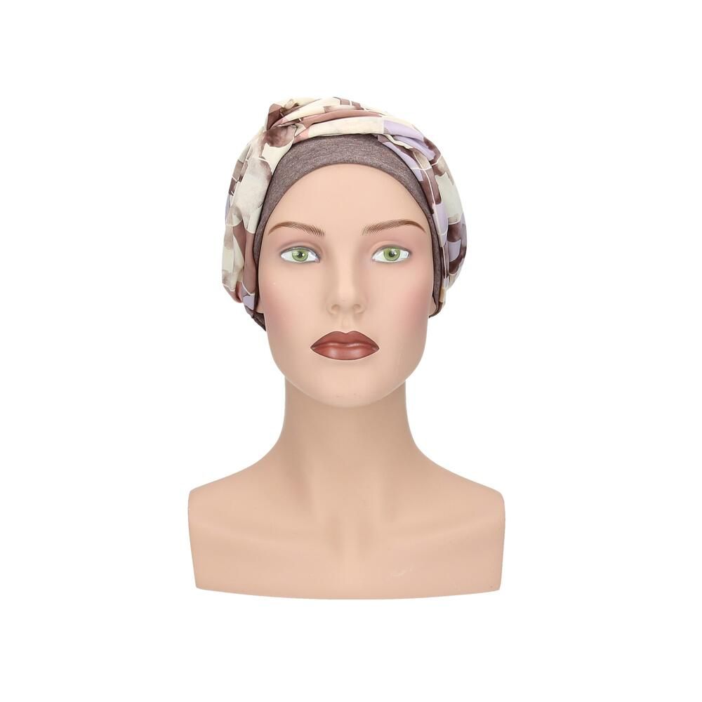 Turban Nora, floral Muster. Grauer Stoff, floraler Überwurf. Auf einer Büste präsentiert.