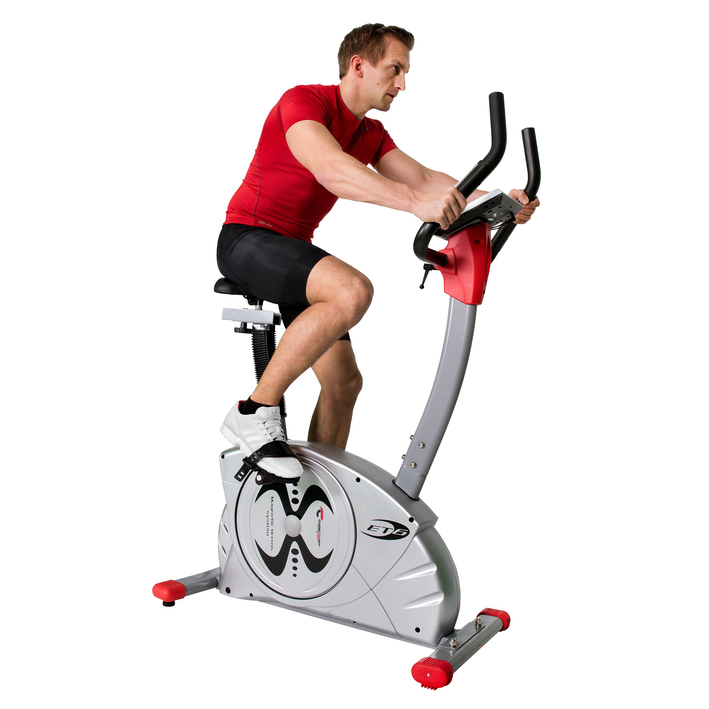 Person auf Ergometer ET 6. Silberfarbenes Fitnessgerät. Roter Akzent. Person in Sportkleidung. Digitalanzeige.