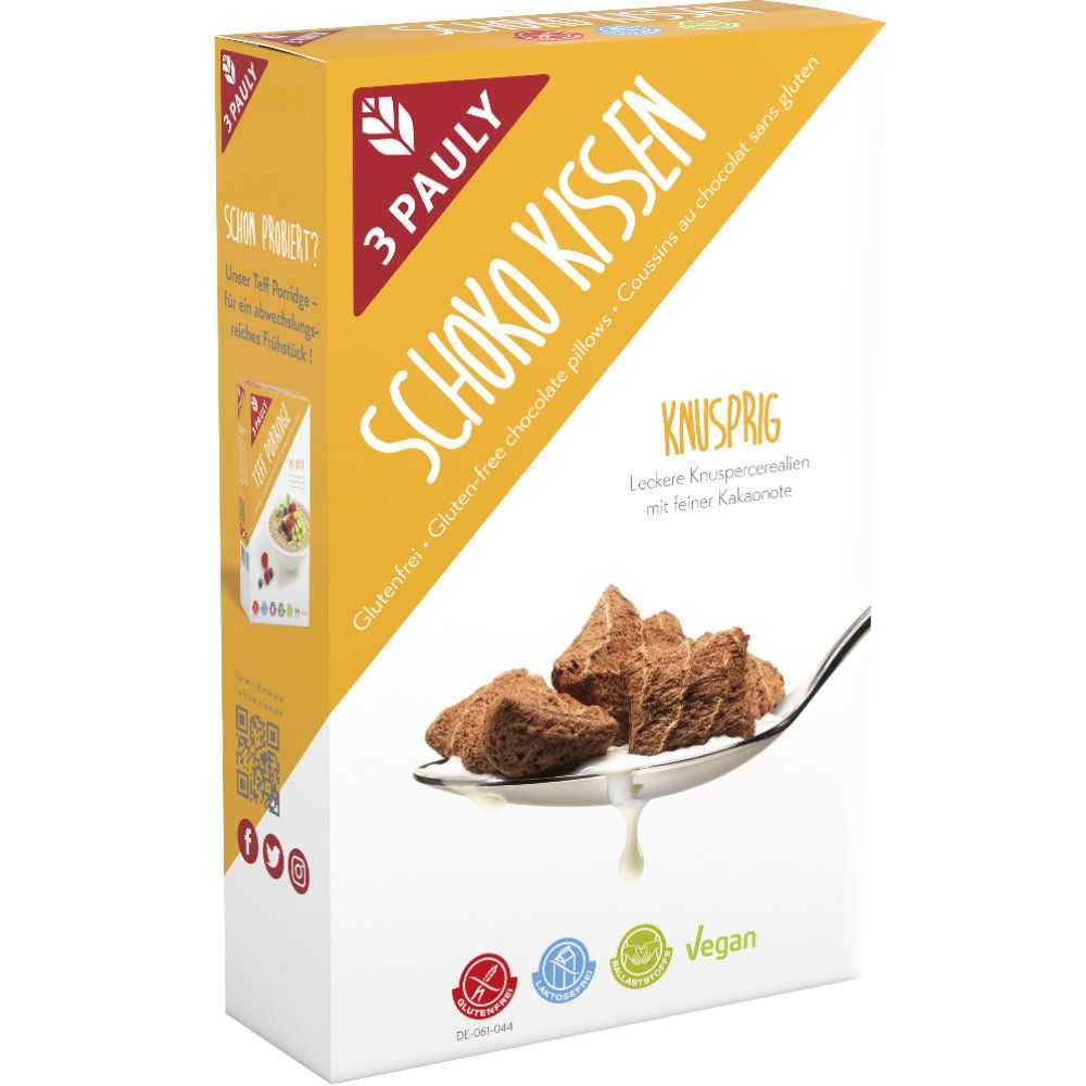 Verpackung von 3 Pauly Schoko Kissen. Gelb-weiße Schachtel mit Produktnamen und Logo. Glutenfrei, vegan. Schoko-Kissen auf einem Löffel.