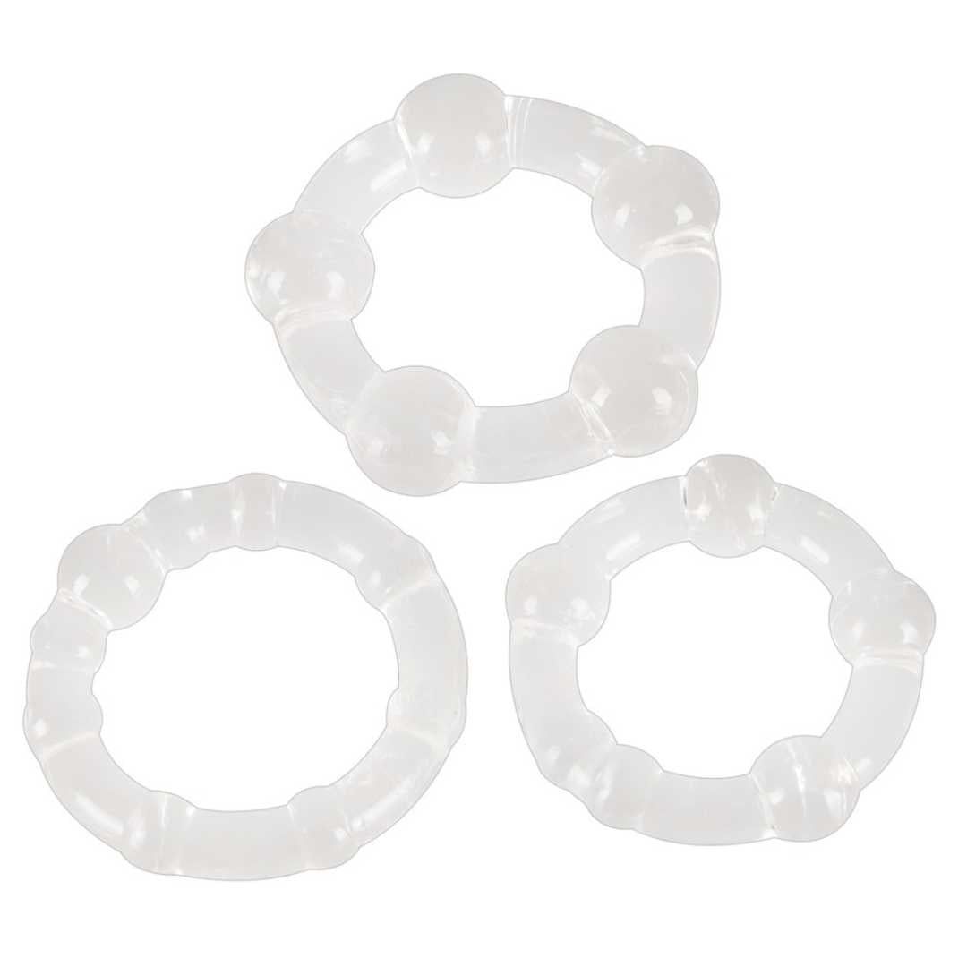 Drei transparente Penisringe mit unterschiedlichen Designs. Sie sind aus Silikon gefertigt und haben eine runde Form.