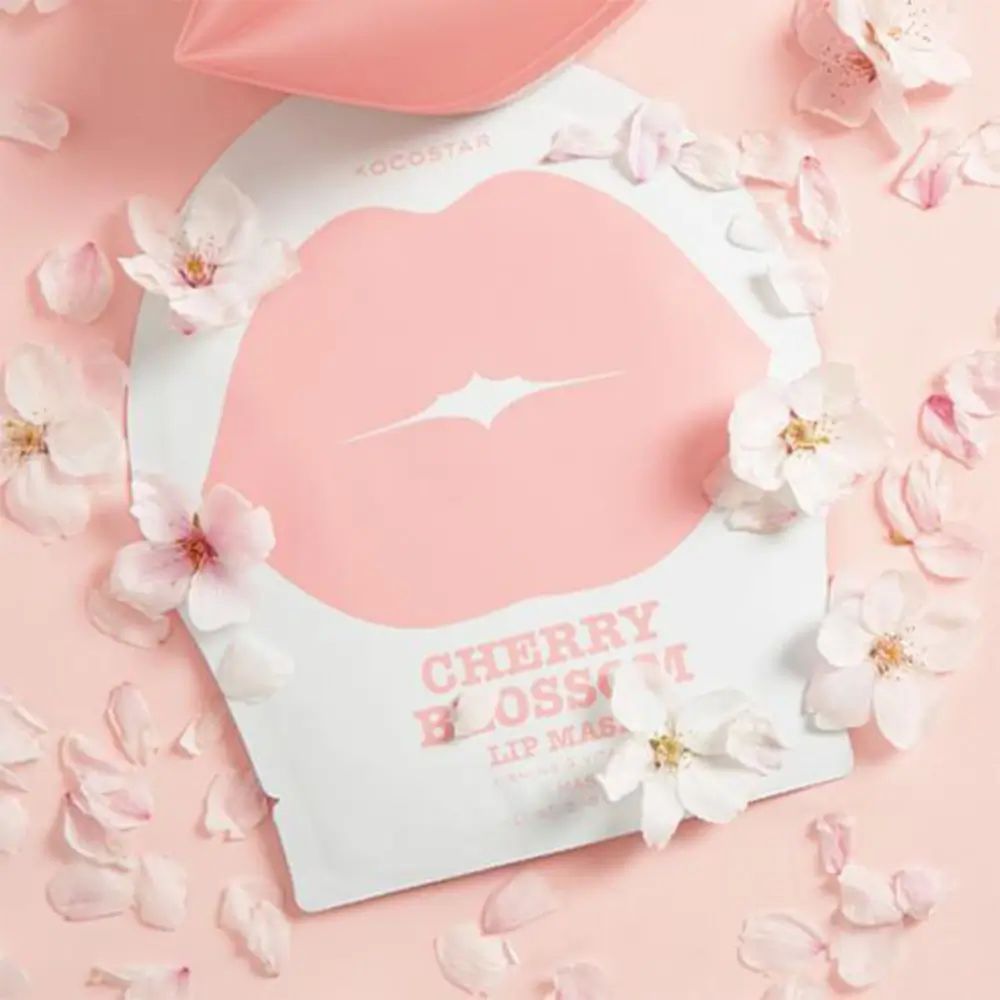 Verpackung mit Lippenmaske und Kirschblüten. Rosa Lippenform auf weißem Hintergrund. Text: Cherry Blossom Lip Mask.