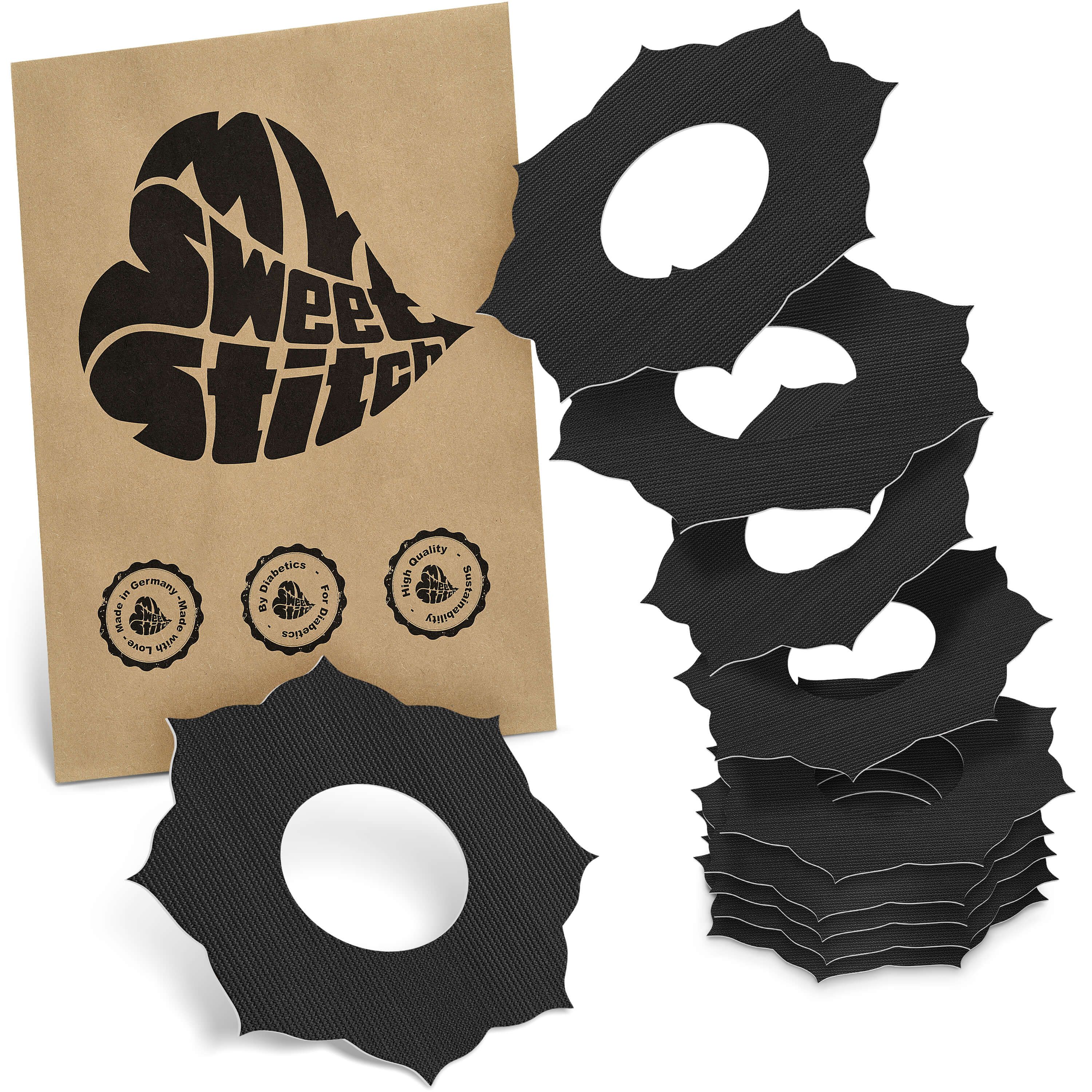 Schwarze, blütenförmige Ringe mit Loch, neben brauner Verpackung mit Logo. Siegel: "Made in Germany", "Best Quality".