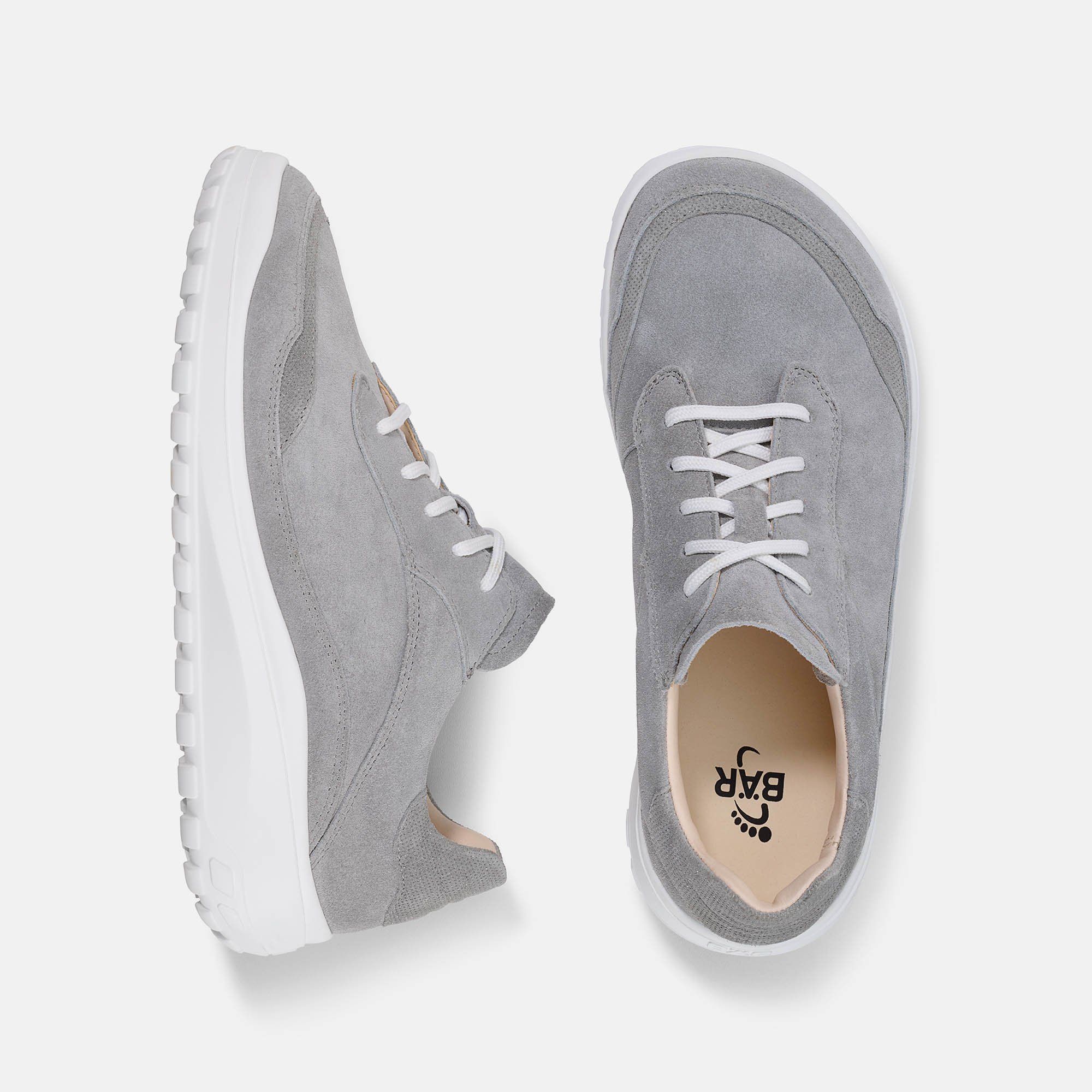 Graue Schnürschuhe mit weißer Sohle. Draufsicht auf zwei Schuhe. Logo im Schuh. Breites Modell.