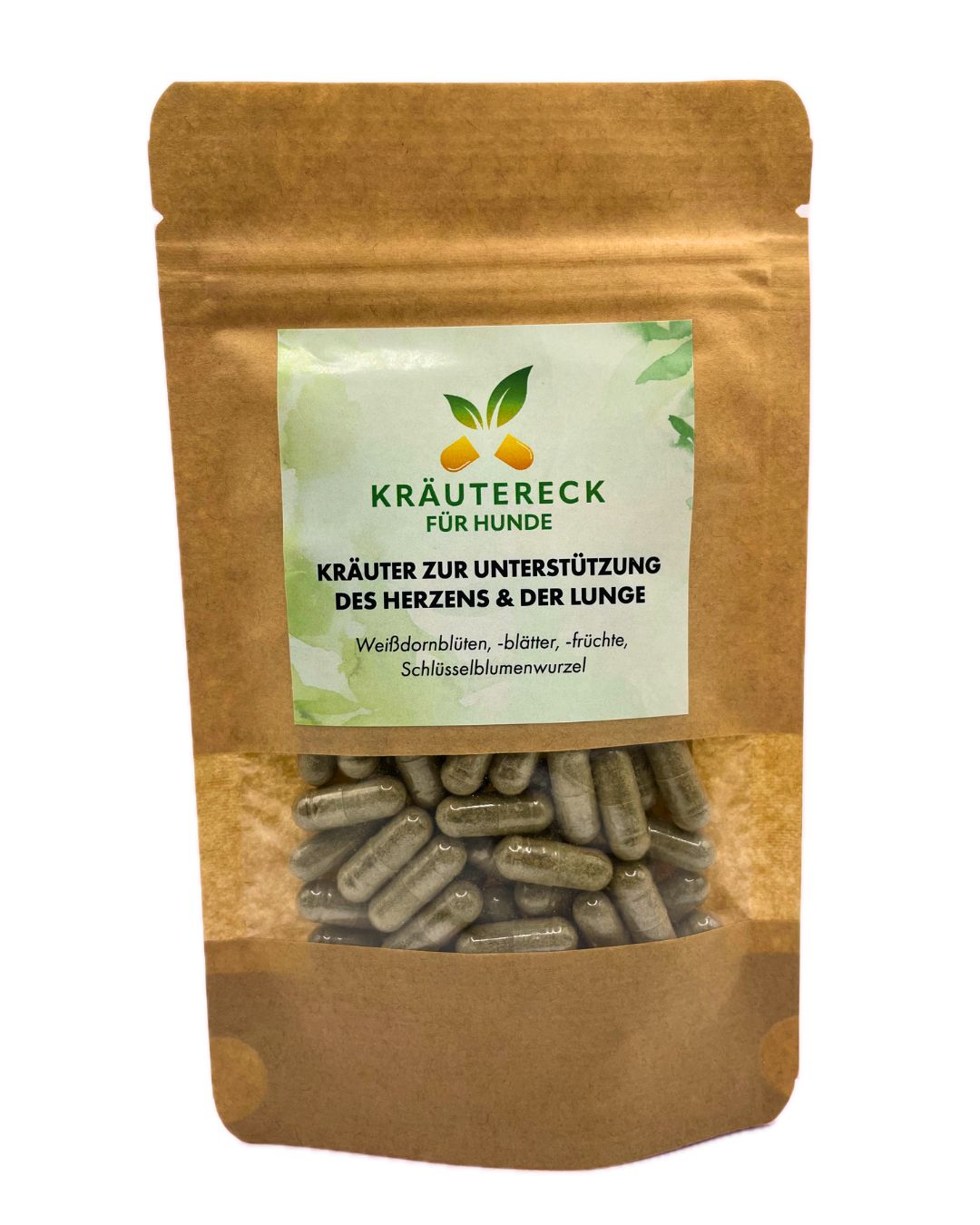 Braune Tüte mit Kräuterkapseln. Etikett mit Text: Kräutereck für Hunde, Kräuter für Herz & Lunge. Sichtbare Kapseln.