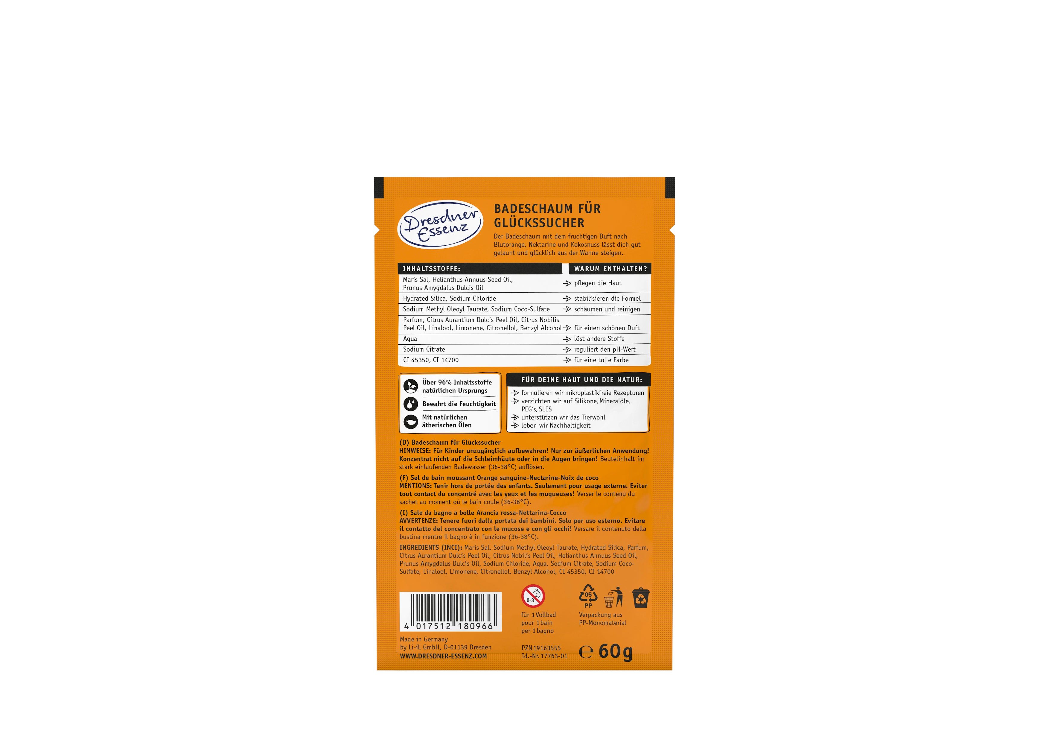 Achterkant van de oranje verpakking. Tekst: badschuim voor gelukzoekers. Ingrediënten, instructies, logo: Dresdner Essenz.