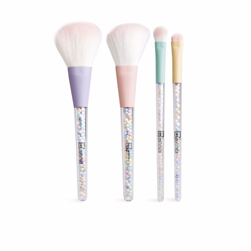 Vier Make-up-Pinsel mit pastellfarbenen Griffen und transparenten Stielen mit bunten Kügelchen. Die Pinselköpfe sind weiß.