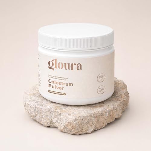 Weißer Behälter mit Aufschrift Gloura auf einem Stein. Beige Hintergrund.