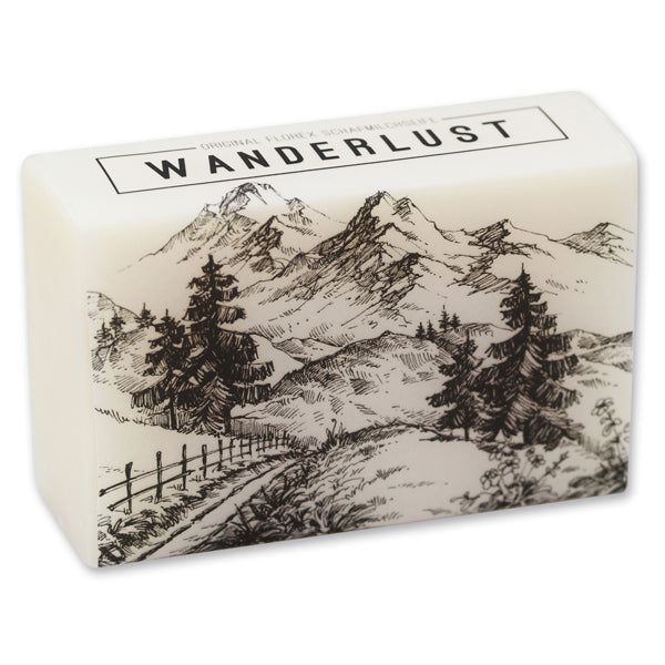 Rechteckige Seife mit Berglandschaft-Illustration. Text: WANDERLUST. Marke: Florex. Schafmilchseife.