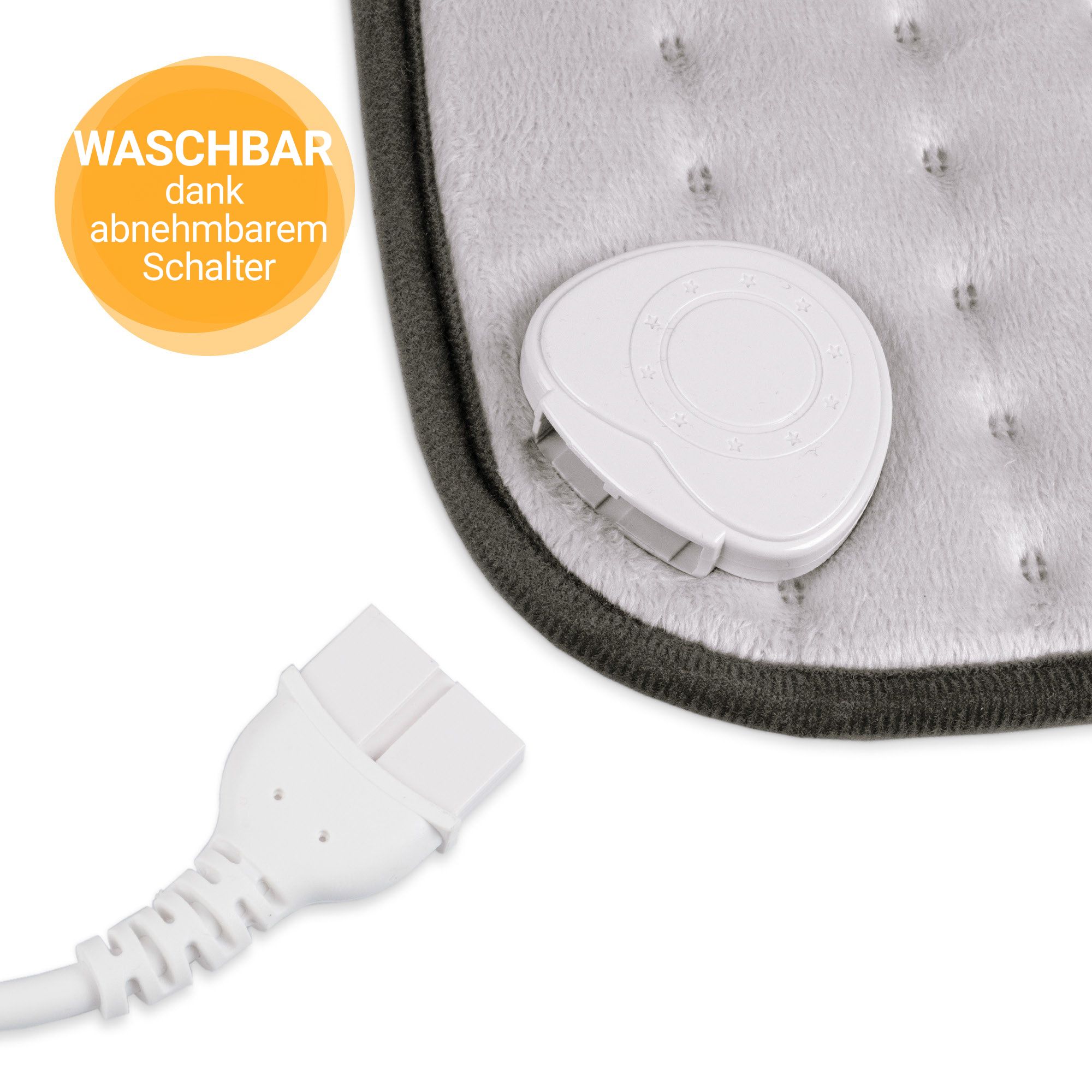 Nahaufnahme: abnehmbarer Schalter und Stecker eines grauen Heizkissens.