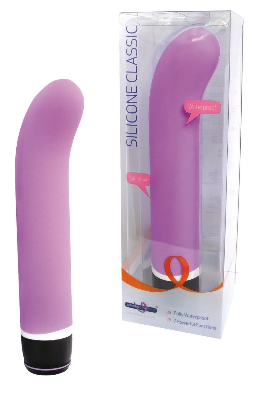 Lila Vibrator, teilweise in Verpackung. Aufschrift "SILICONE CLASSIC". Schwarzer Sockel. Wasserdicht.