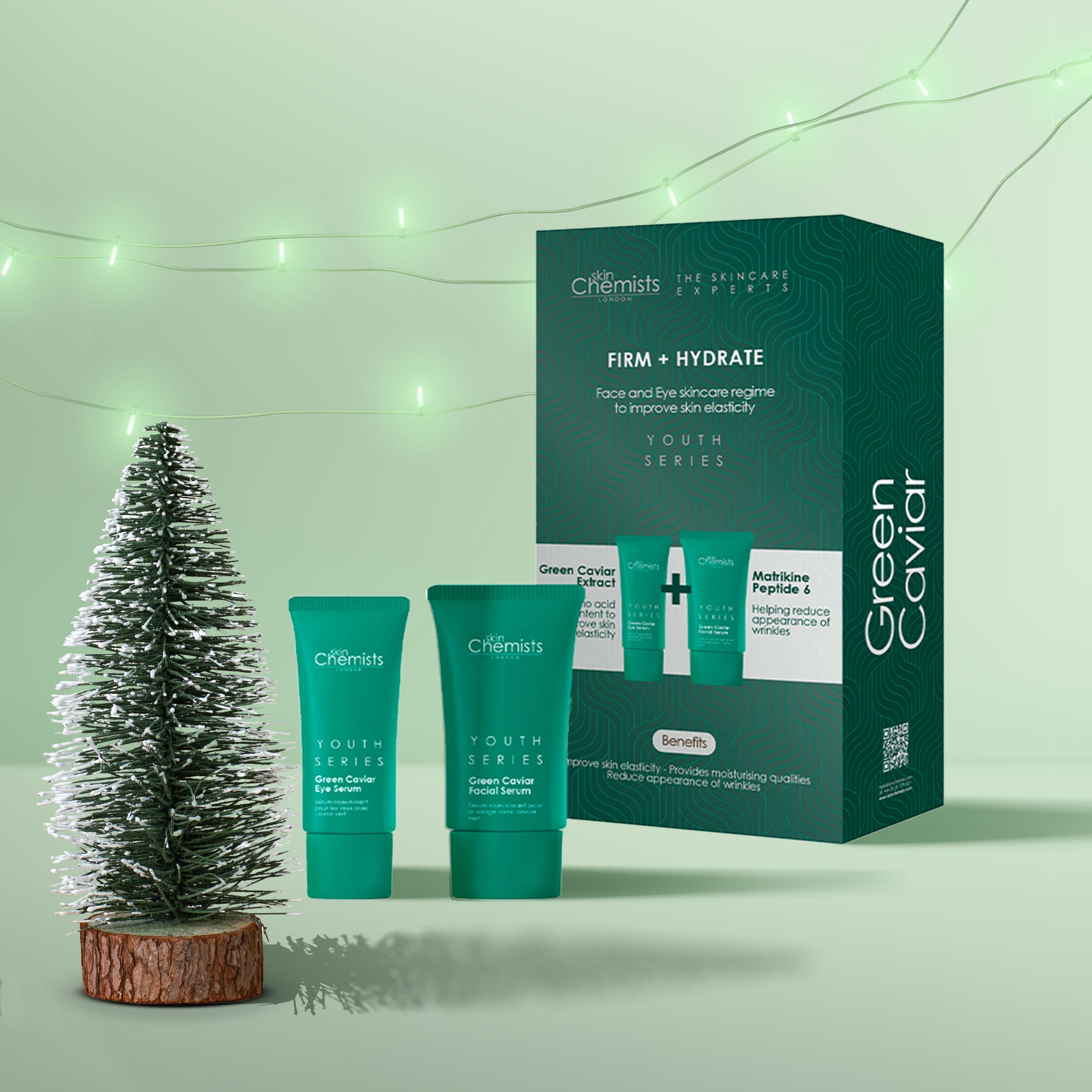 Grünes Kaviar Augen- und Gesichtsserum. Zwei Tuben und eine Verpackung. Grün und weiß. Weihnachtsbaum. Text: Skin Chemists, Youth Series, Green Caviar.