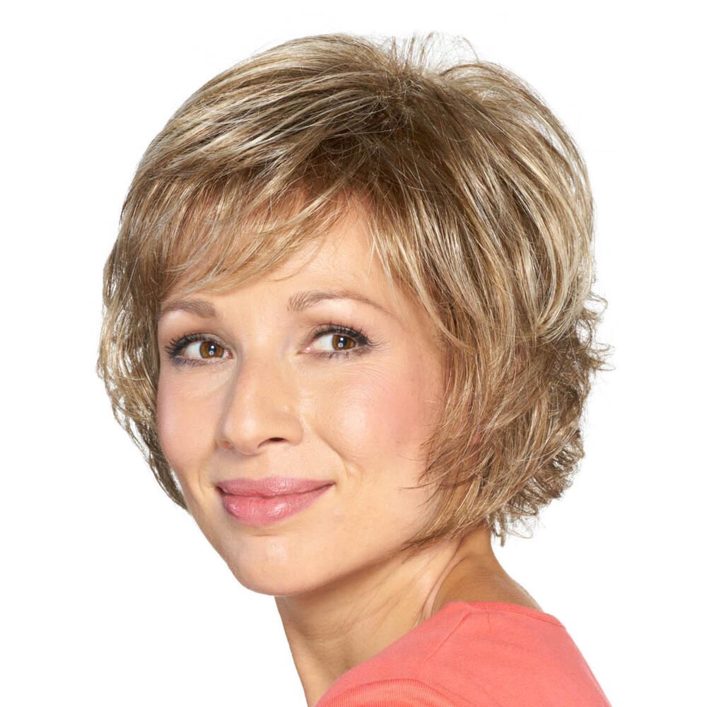 Kurzhaarperücke mit blond-braunem Haar. Die Frau lächelt und blickt zur Seite. Rosa Oberteil.