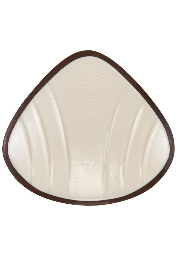 Brustprothese, cremefarben, tropfenförmig. Mit geriffelter Oberfläche und braunem Rand.