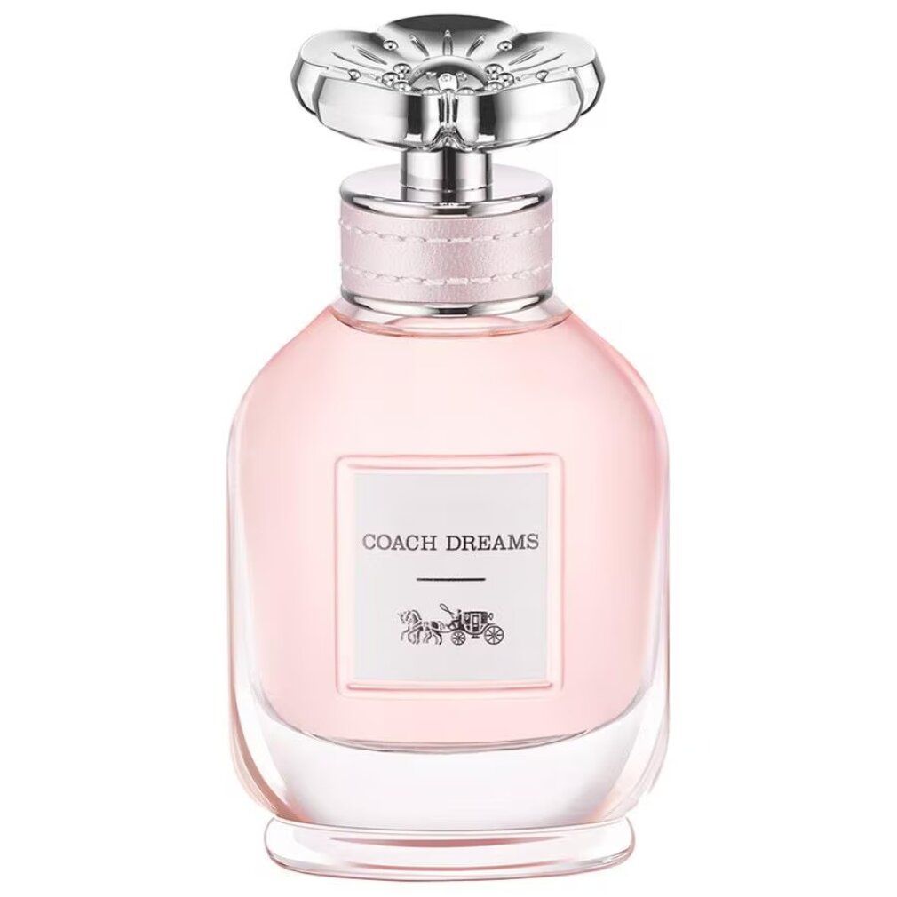 Rosa Glasflasche mit silbernem Deckel. Aufkleber "COACH DREAMS" und Kutschen-Logo. Flasche steht.
