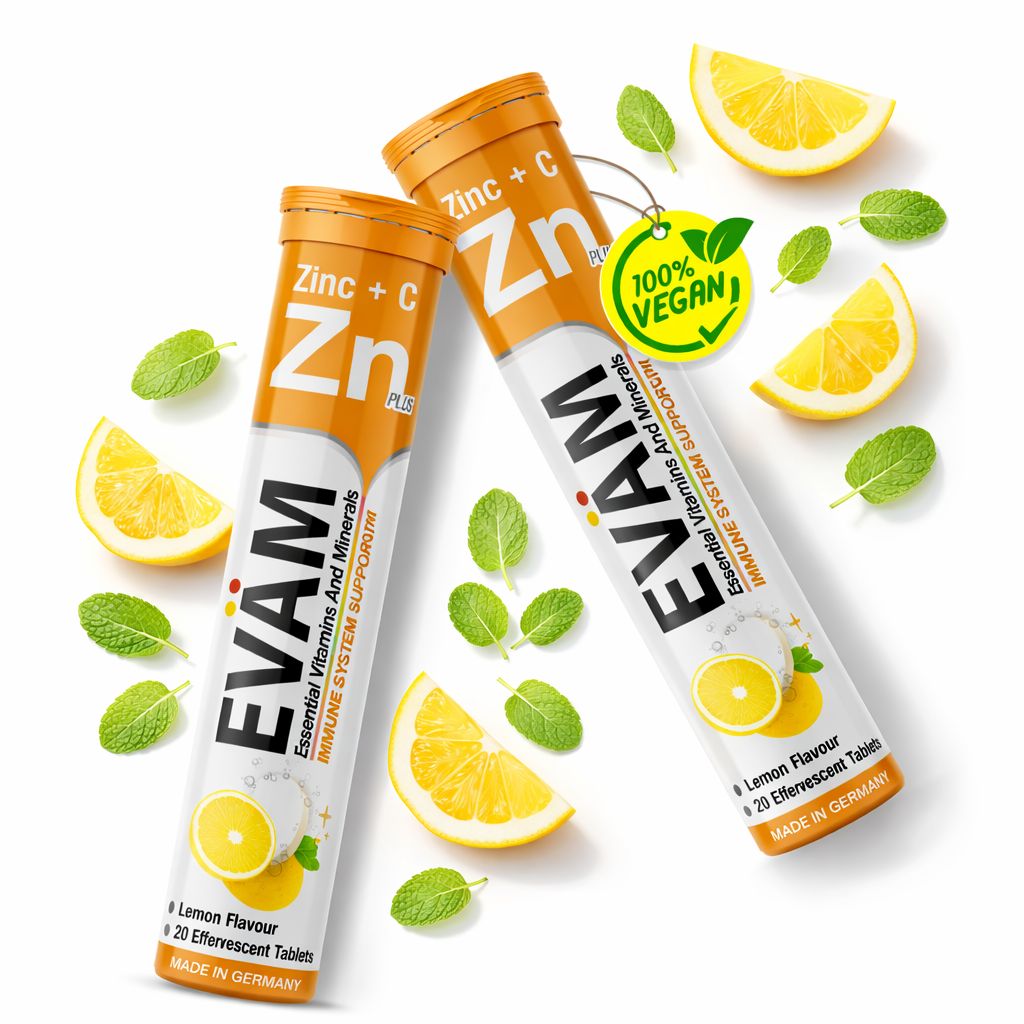 Zwei Tuben EVÄM Vitamin C + Zink. Orangefarbene Deckel, weißer Körper. 100% Vegan-Label. Zitronen und Minzblätter als Dekoration.
