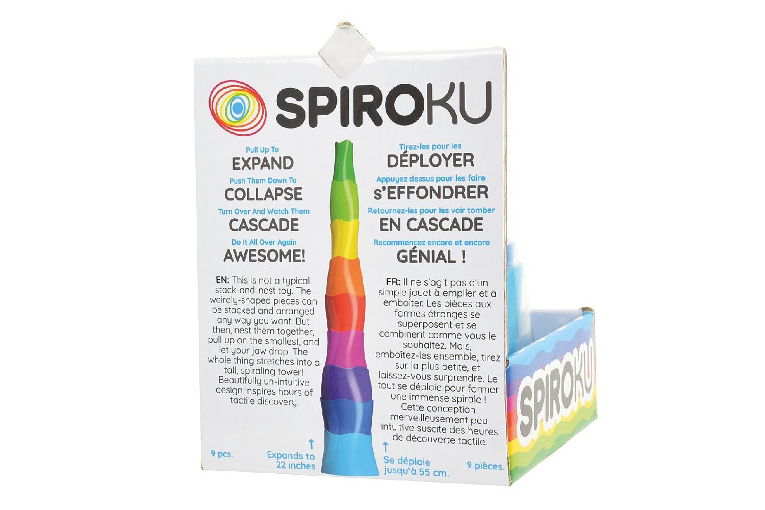 SpiroKu-Verpackung. Zylinder-Spielzeug in Verpackung. Text: Expand, Collapse, Cascade. Mehrfarbige Zylinder, blau unten, grün oben.