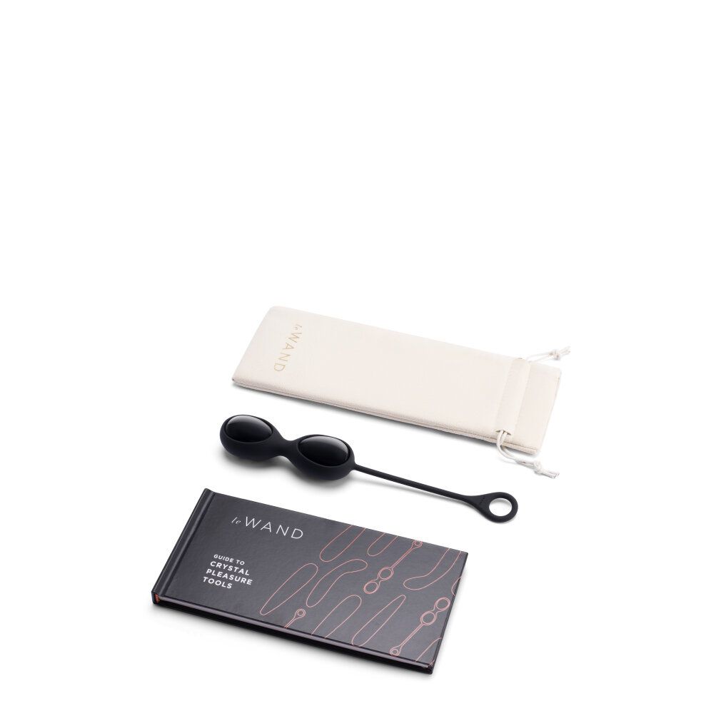 Zwei Obsidian-Eier, Beutel und Buch. Buch: Guide to Crystal Pleasure Tools.