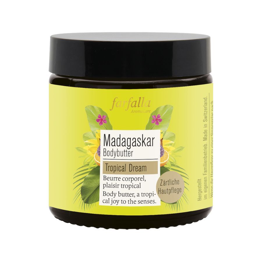 Braunes Glas mit gelbem Etikett. Aufschrift: Madagaskar Bodybutter Tropical Dream. Schwarzer Deckel. Farfalla Logo.