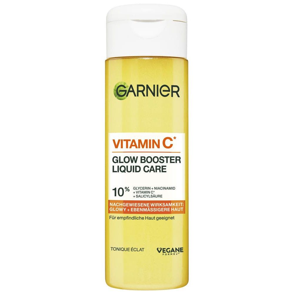 Garnier Vitamin C Glow Booster Liquid Care. Gelbe Flasche mit weißem Deckel. Text: Vitamin C, Glow Booster, 10%. Vegane Formel.