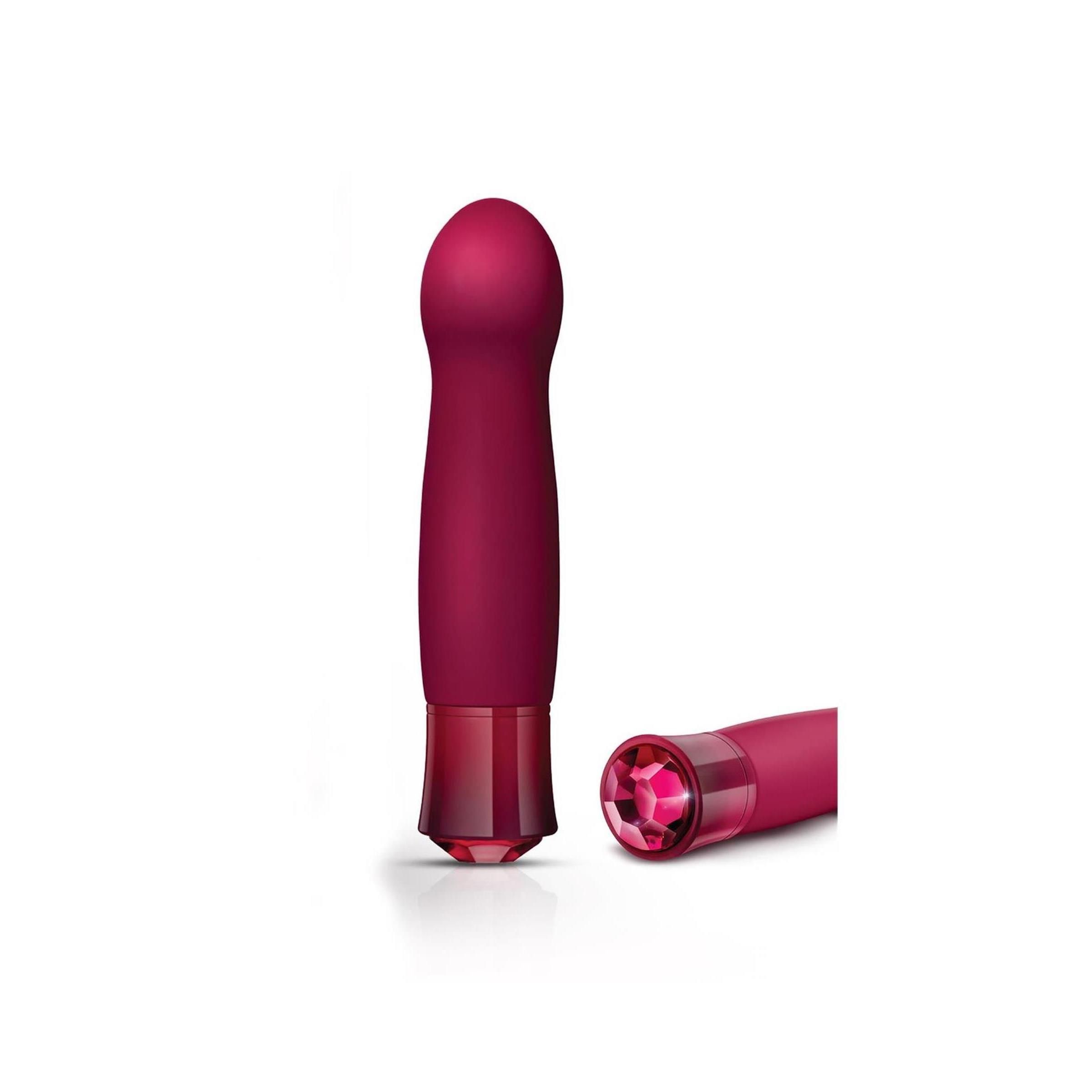 Zwei Vibratoren. Einer steht aufrecht, der andere liegt. Beide haben eine runde Spitze und einen Kristallfuß.