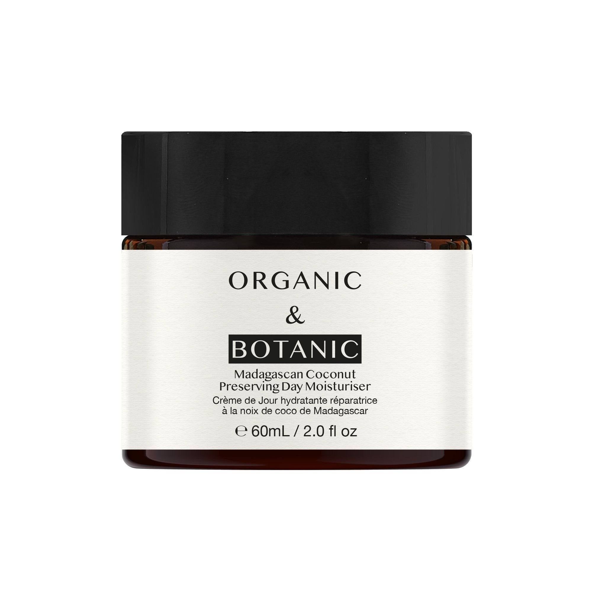Cremebehälter mit schwarzem Deckel. Aufschrift: ORGANIC & BOTANIC, Madagascan Coconut Preserving Day Moisturiser. 60ml/2.0 fl oz.