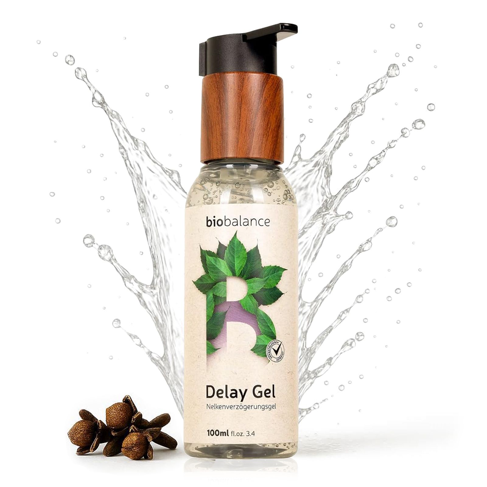 Flasche Delay Gel mit Nelken. Wasser spritzt. Holzdeckel. Logo und Produktname sichtbar.