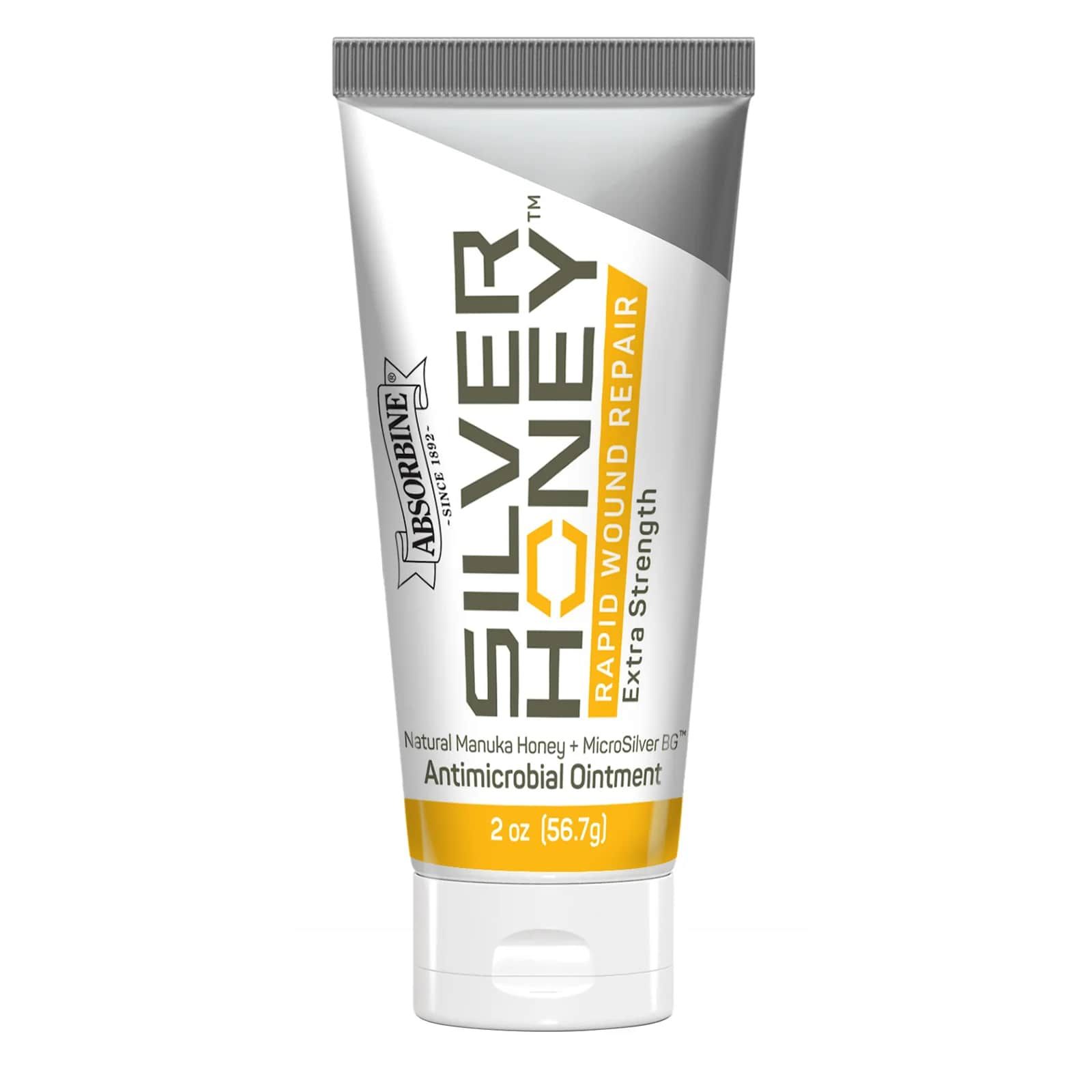 Tube mit Produktnamen und Logo. Hauptfarben: Weiß, Grau, Gelb. Text: SILVER HONEY, RAPID WOUND REPAIR, Antimikrobielle Salbe. 2 oz (56.7g).