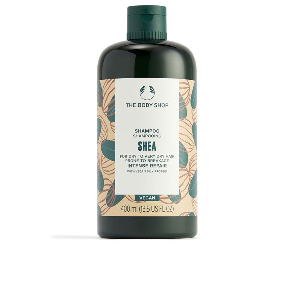 Dunkelgrüne Shampoo-Flasche mit weißem Etikett. Aufschrift: Shea, Shampoo, Vegan. 400 ml.