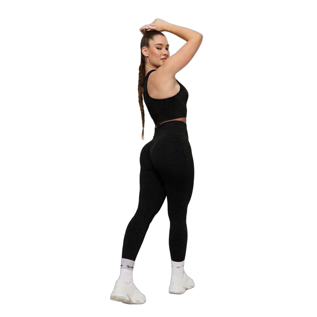Frau in Graphit-Leggings mit hohem Bund und passendem Sport-BH.