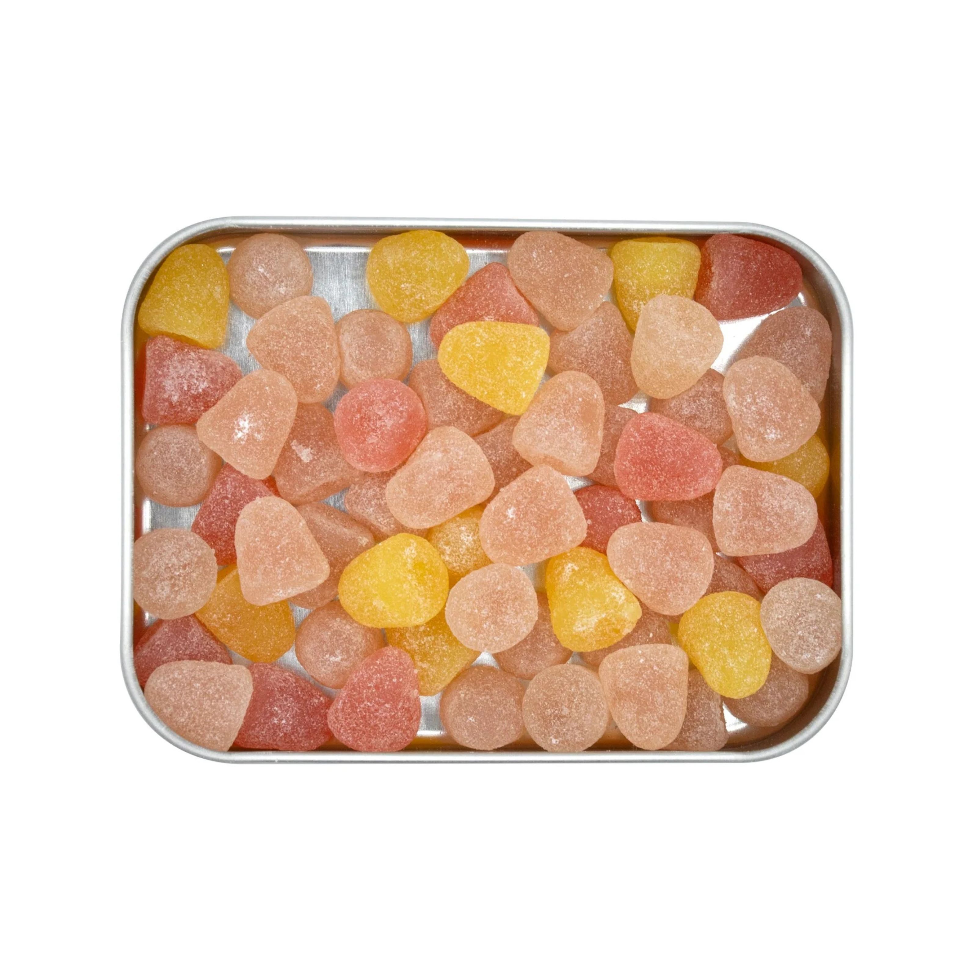 Metallbox gefüllt mit Fruchtgummis in verschiedenen Farben und Formen. Die Gummis sind in Gelb, Rosa und Orange gehalten.