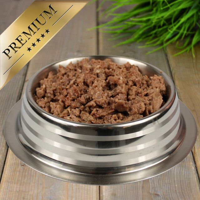 Hundefutter in einer Edelstahlschüssel. Goldene Plakette: 'Premium'.