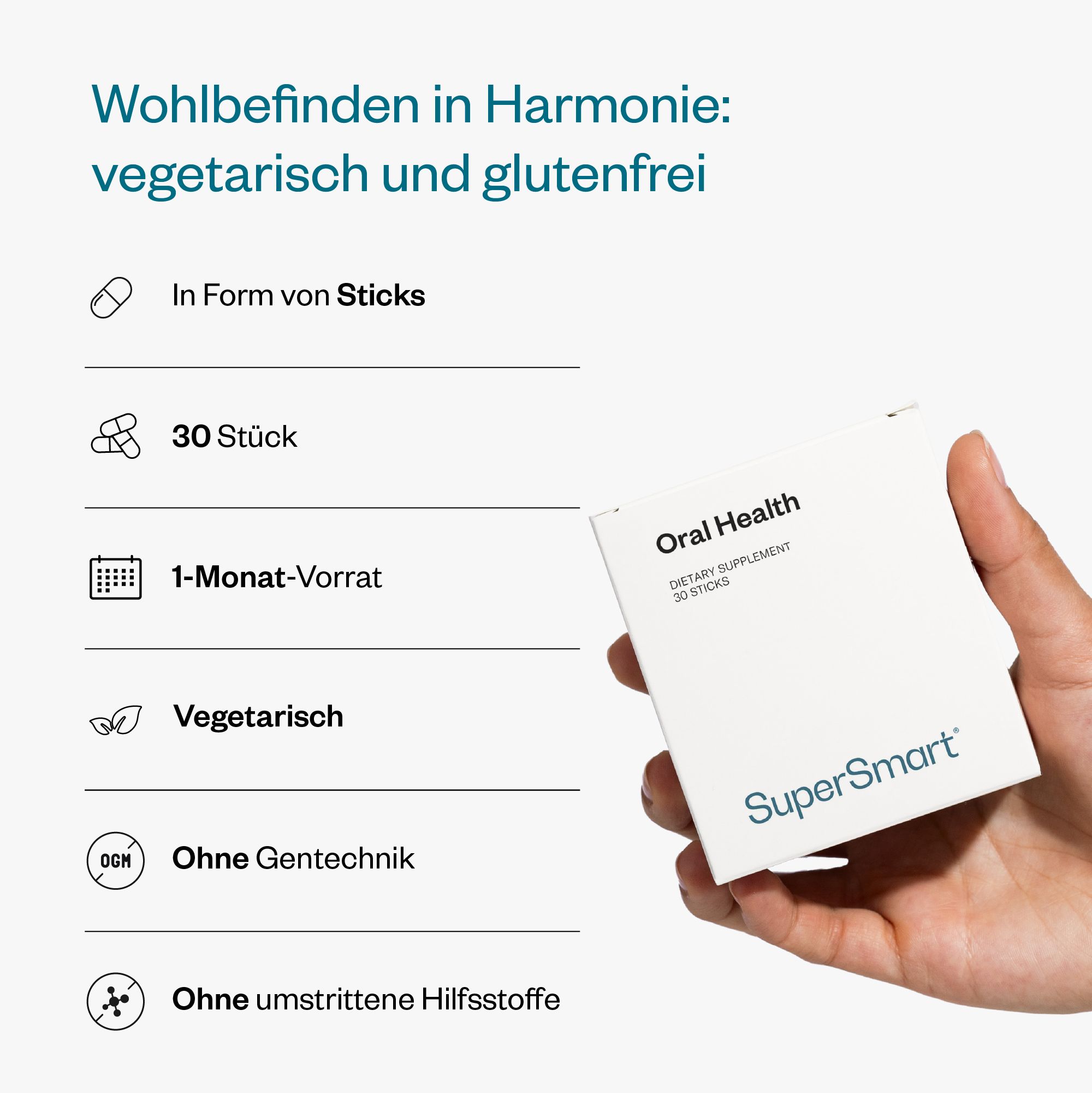 Hand hält weiße Verpackung Oral Health, 30 Sticks. Vegetarisch, glutenfrei, ohne Gentechnik. Marke: SuperSmart.