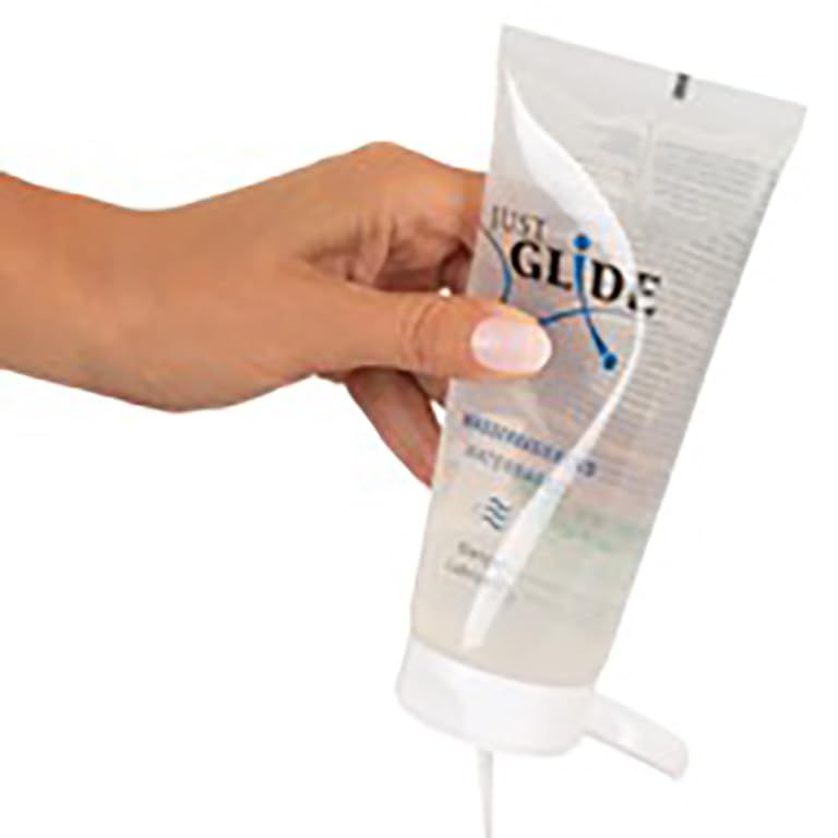 Just Glide Wasserbasierend Gleitgel Tube mit blauem Logo und Wellenmuster.